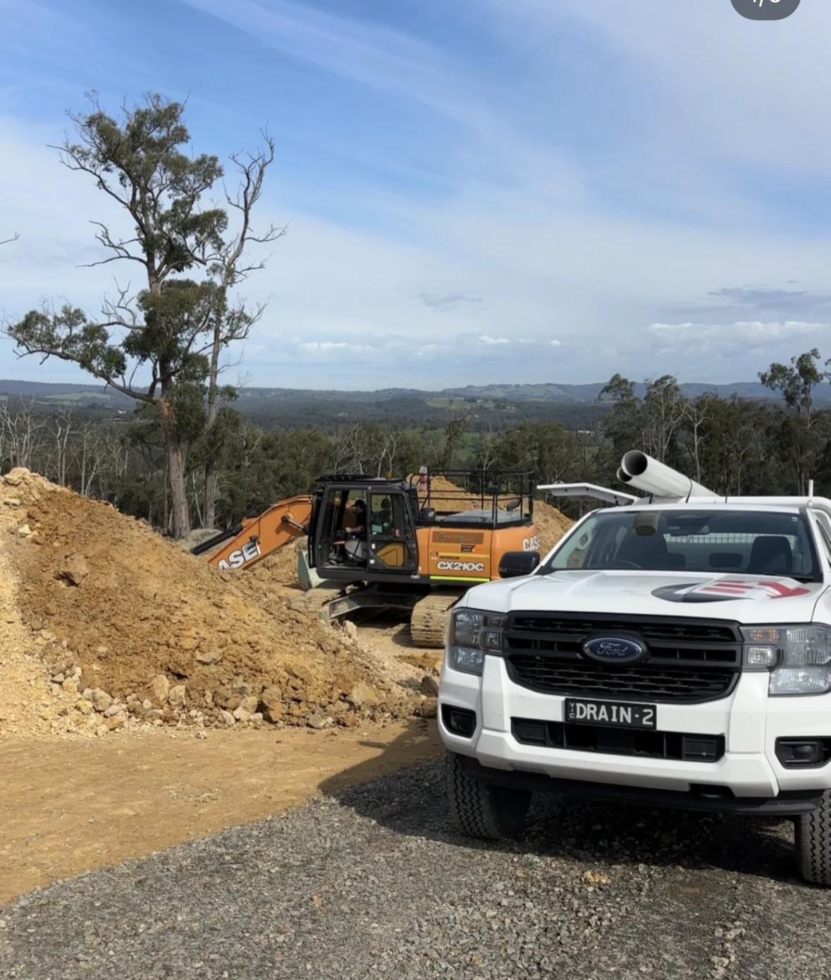 Barrel Plumbing vehicle and excavator working on a rural property in Victoria