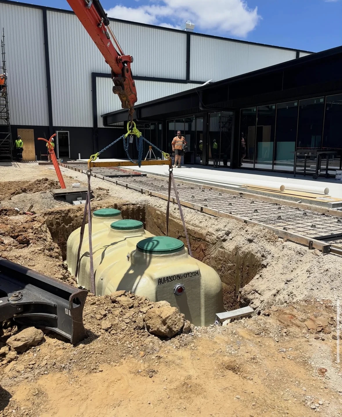 A FujiClean ACE3000 wastewater treatment system being lowered into position